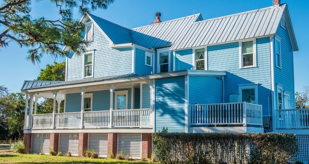 Blue siding house with silver metal roof